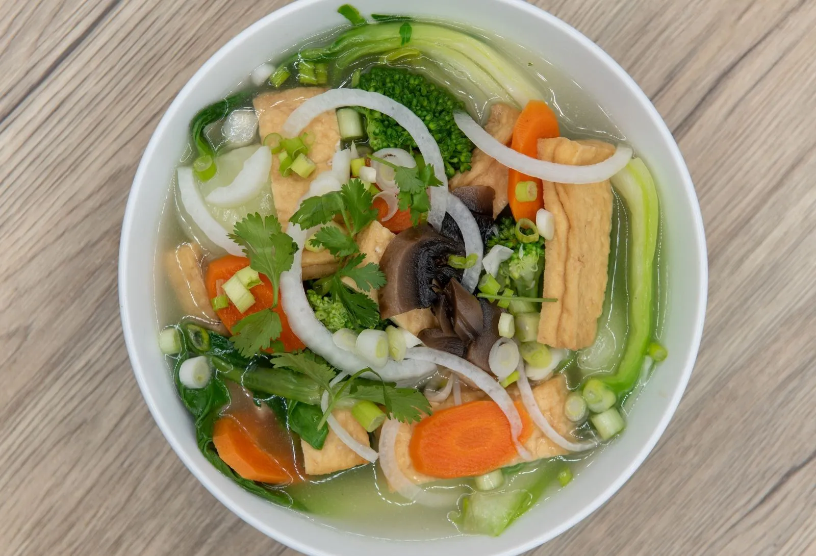 Vegetable tofu soup loaded with mixed fresh veggies and aromatic herbs at O E C Asian Fusion Restaurant in Picayune