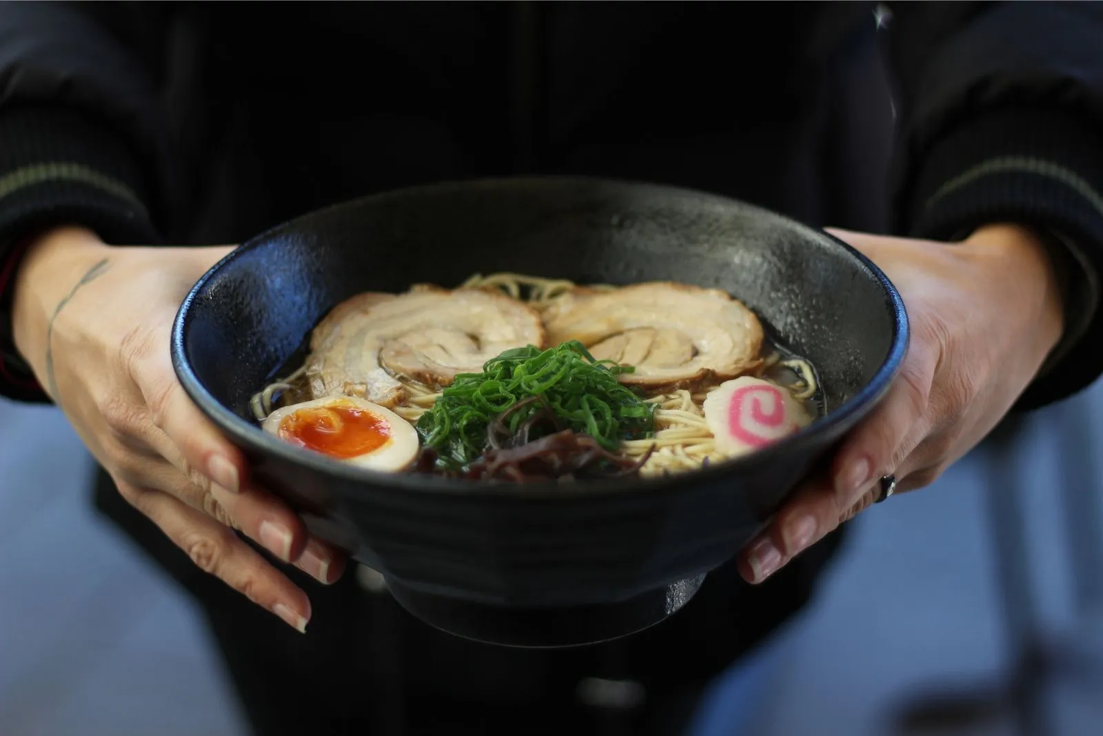 Rich tonkotsu ramen with chashu pork, soft egg and seaweed garnish at O E C Asian Fusion Restaurant in Picayune